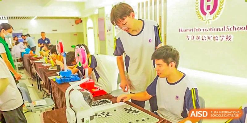 Guangzhou Huamei International School students focused on a game of Go on a board.