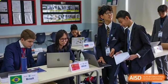A photo showing students using laptops in a classroom, at The British School of Beijing, Shunyi.