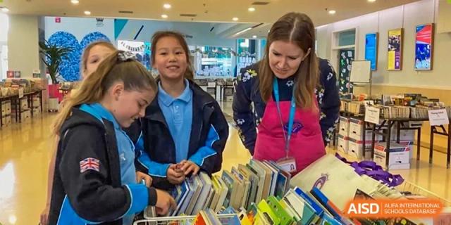 A photo showing students in a library, at The British School of Beijing, Shunyi.