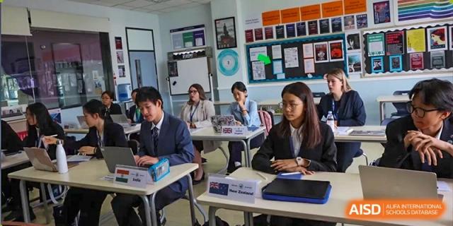 A photo showing a group of students sitting in a classroom with a teacher, at The British School of Beijing, Shunyi.