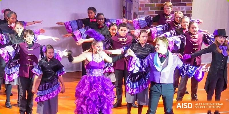 A photo showing students performing on a stage. They are performing some kind of play, at The British School of Beijing, Shunyi.