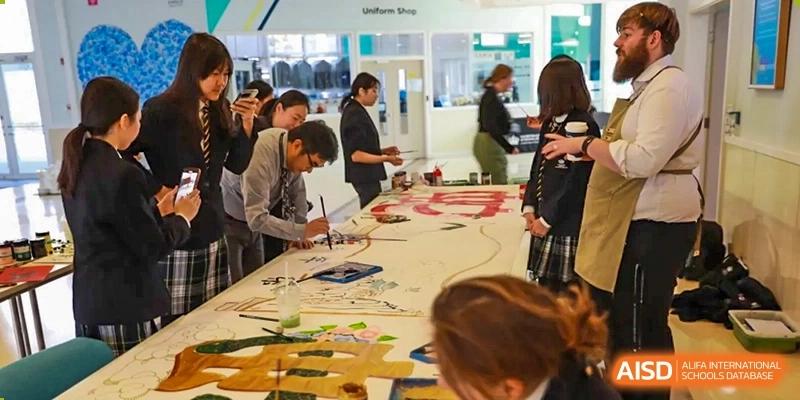 A photo showing a group of students doing some kind of art project, at The British School of Beijing, Shunyi.