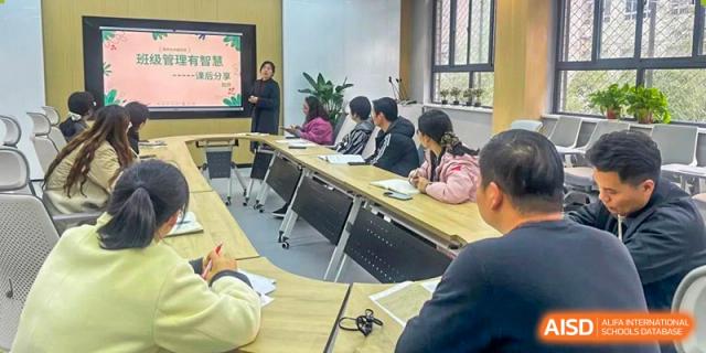 An academic or discussion meeting with Zhengzhou No.9 High School International Department students and a teacher seated around a conference table.