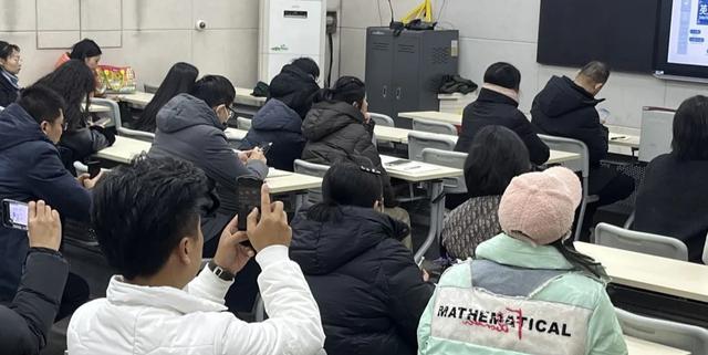 A large group of Zhengzhou No.9 High School International Department students seated in a lecture hall or large classroom.