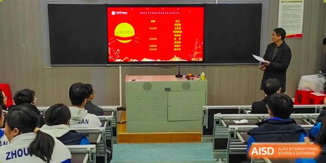 An empty classroom at Zhounan High School showing a large electronic display with a red screen and Chinese text.