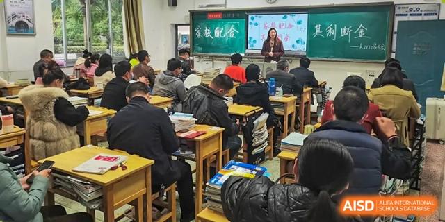 Students from Zhounan High School attending a lecture or class in a brightly lit classroom.