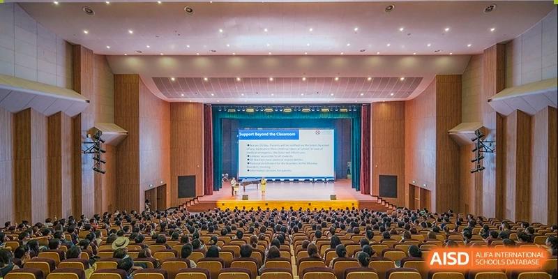 An auditorium filled with students listening to a presentation. Hangzhou Dipont School of Arts and Science.