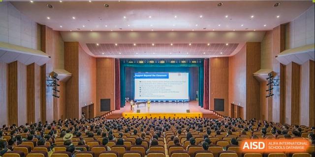 An auditorium filled with students listening to a presentation. Hangzhou Dipont School of Arts and Science.