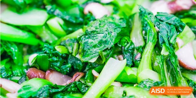 A close-up shot of fresh green leafy vegetables. Hangzhou Dipont School of Arts and Science.