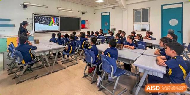Students from Ningbo Huamao International School seated at desks, facing the front of the classroom.
