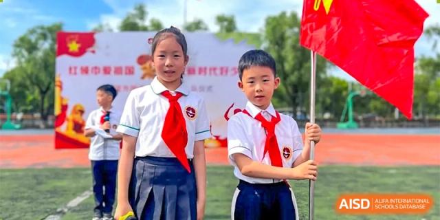 Two students from Ningbo Huamao International School, in school uniforms, posing for a photo.