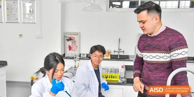 Qingdao MINGDE School students in lab coats conducting an experiment.