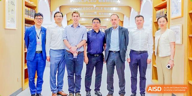 A group of male staff and teachers from Qingdao MINGDE School standing together.