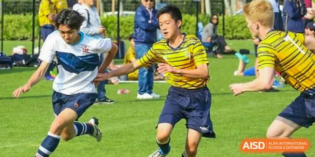 A student from Dulwich College Shanghai Pudong running with a ball during a game.