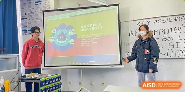 A presentation slide about chatbots is projected on a screen in a classroom at Qingdao No.1 International School of Shandong Province (QISS).