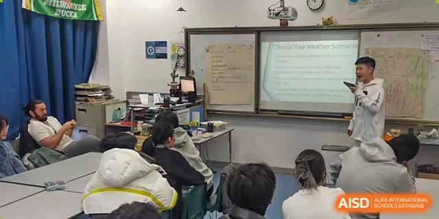 Students work at their desks in a classroom with a whiteboard at Qingdao No.1 International School of Shandong Province (QISS).