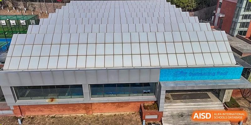 The exterior of a school building with large windows at Qingdao No.1 International School of Shandong Province (QISS).