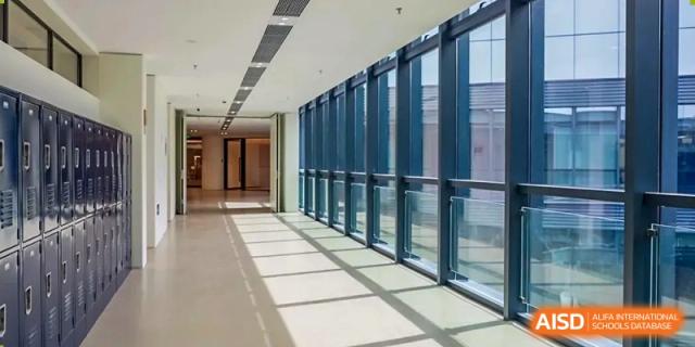 A bright, empty hallway with large windows at Qingdao No.1 International School of Shandong Province (QISS).