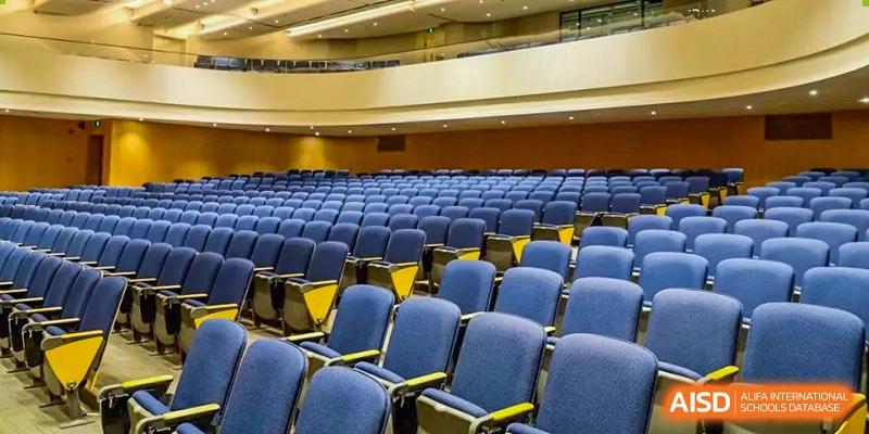 Rows of blue seats in a school auditorium at Qingdao No.1 International School of Shandong Province (QISS).