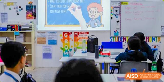 A digital screen at Shenzhen Oasis International School displays an academic lesson with a cartoon character.
