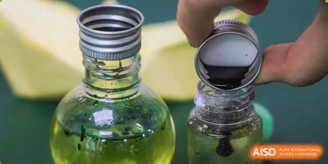 Science experiment with glass bottles and green solution at Shenzhen Oasis International School