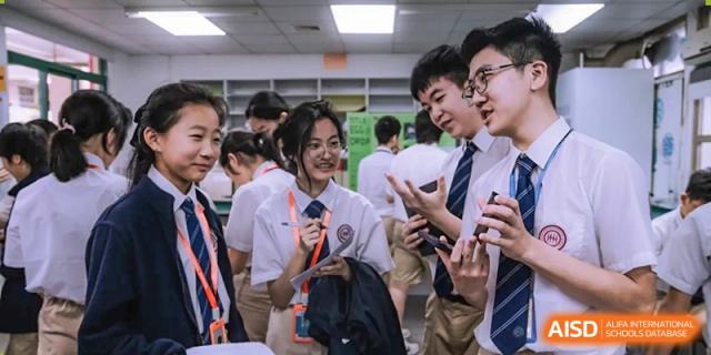 Students from Shenzhen Oasis International School smiling and laughing in a group.
