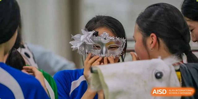 A student from Shenzhen Oasis International School wearing a silver masquerade mask.