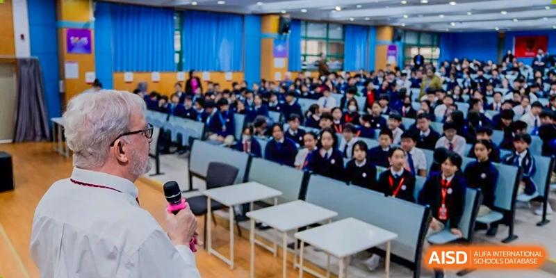 Students from Shenzhen Oasis International School attend a school assembly in an auditorium.