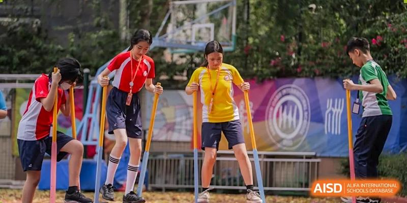 Students from Shenzhen Oasis International School participate in a walking stilts activity.