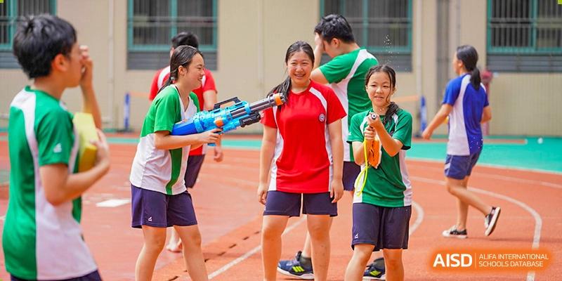 Students from Shenzhen Oasis International School play with water guns during a school activity.