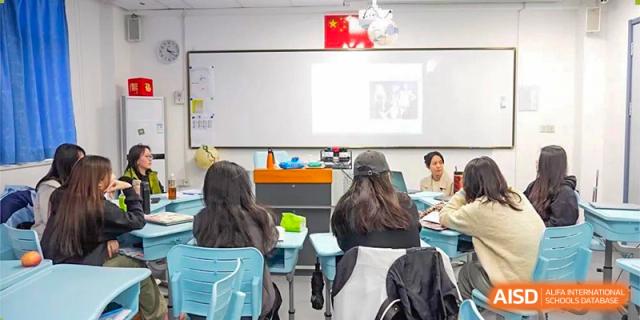 Students from World Leading Schools Association collaborating or taking notes in a classroom setting.