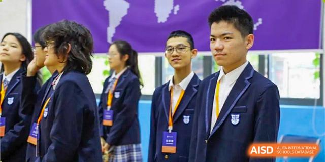 Students from World Leading Schools Association in uniform standing together for a group photo during an event.