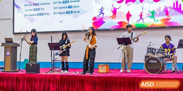 A student from World Leading Schools Association singing and playing a guitar on a stage with a band during a school event.