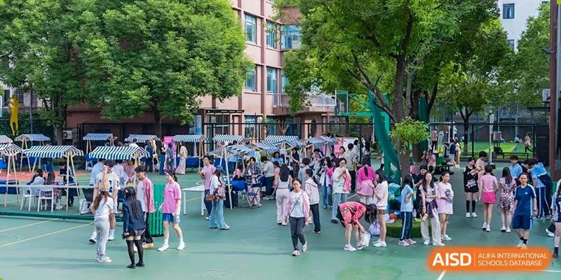 A busy scene of students walking and gathering on a paved outdoor area or plaza at World Leading Schools Association.