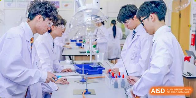 Harrow International School Shenzhen students working with beakers and other lab equipment during a science class.