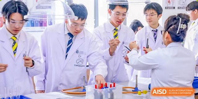 Harrow International School Shenzhen students in lab coats conducting a scientific experiment together.