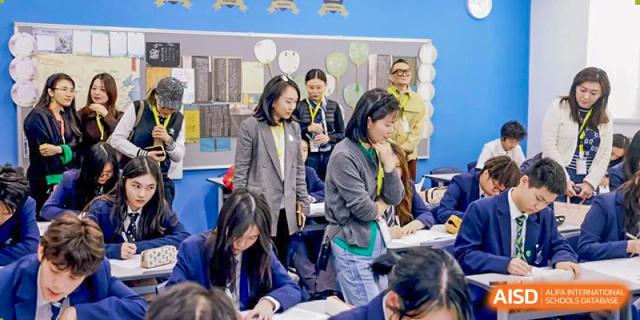 Harrow International School Shenzhen parents and students interacting and looking at work in a classroom.