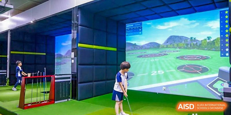 Harrow International School Shenzhen student practicing his swing in an indoor golf simulator.