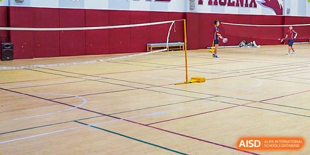 International School of Nanshan Shenzhen indoor volleyball court with the net in place, ready for a game.