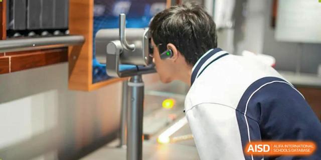 A Shenzhen Yunding School student wearing a headset or headphones, possibly engaged in virtual reality or a technical lesson.