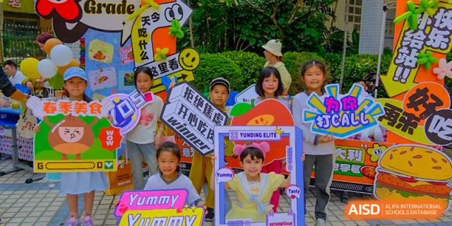 Young students from Shenzhen Yunding School holding promotional signs or banners at an outdoor event.