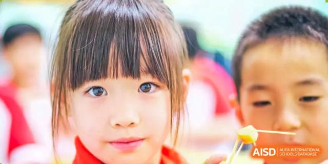 A close-up of a young student from Beijing Concord College of Sino-Canada, with a bright and curious expression.