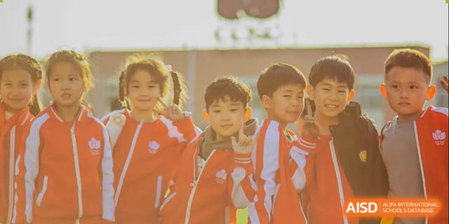A group of young students from Beijing Concord College of Sino-Canada are standing together and smiling for a photo.