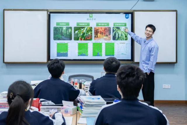 Students from Chongqing BI Academy look at an interactive display of different types of plants.