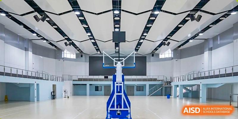 An empty indoor basketball court from a side view at Chongqing BI Academy.
