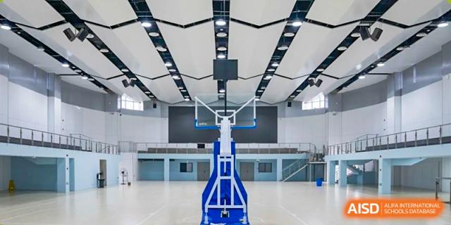 An empty indoor basketball court from a side view at Chongqing BI Academy.