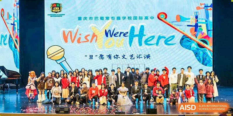 Students from Chongqing BI Academy pose for a group photo in front of a banner.
