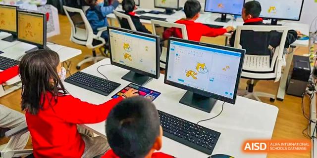 Students from EtonHouse International School Nanjing working on a laptop.