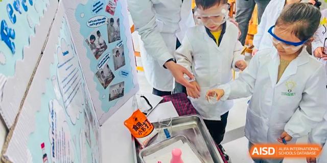 A teacher from EtonHouse International School Nanjing in a lab coat helping a student with a science experiment.