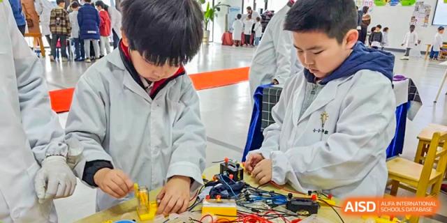 A student from EtonHouse International School Nanjing working on a robotics project.